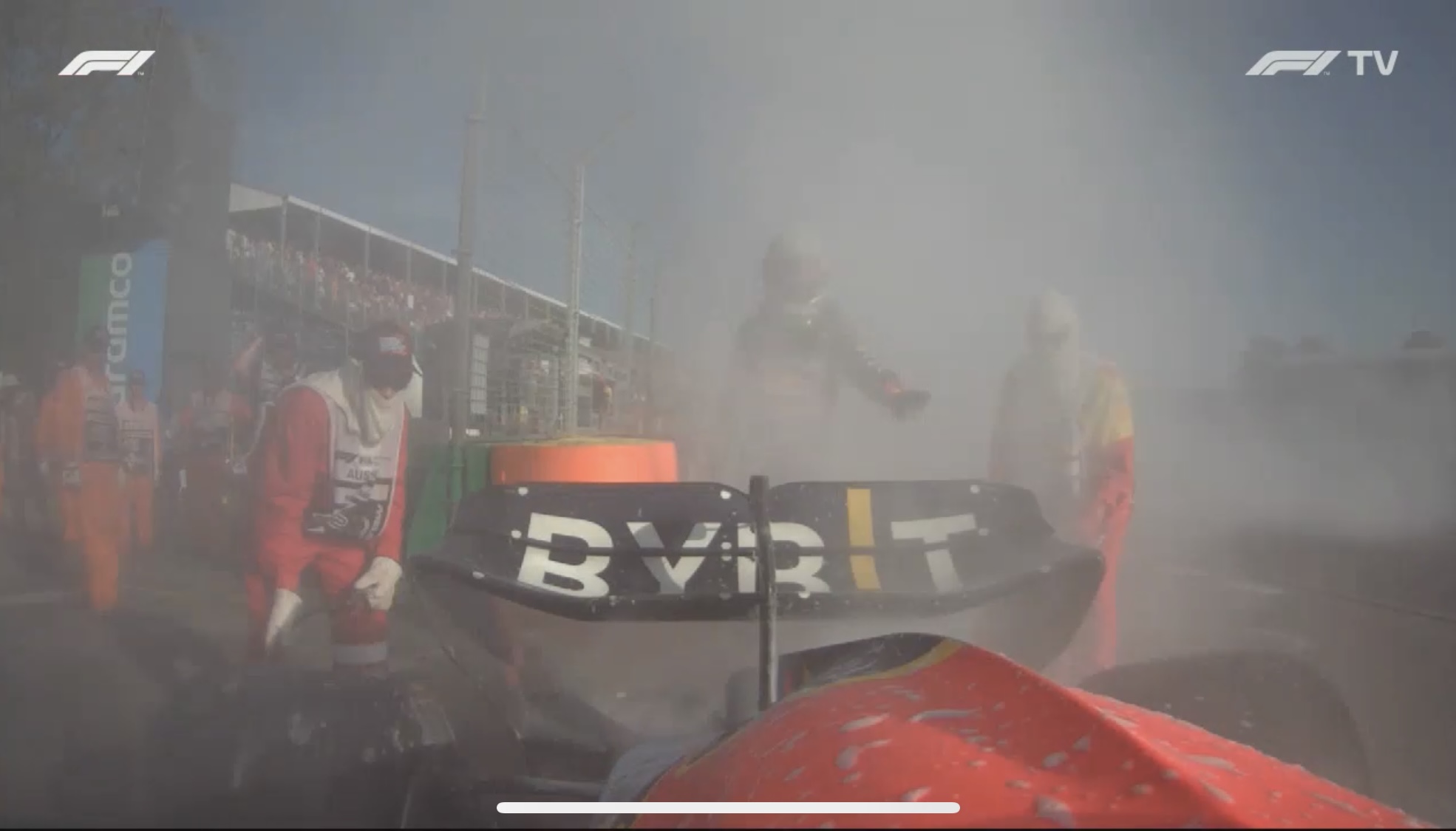 Red Bull Formula 1 car on fire as marshalls and driver Max Verstappen extinguish flames