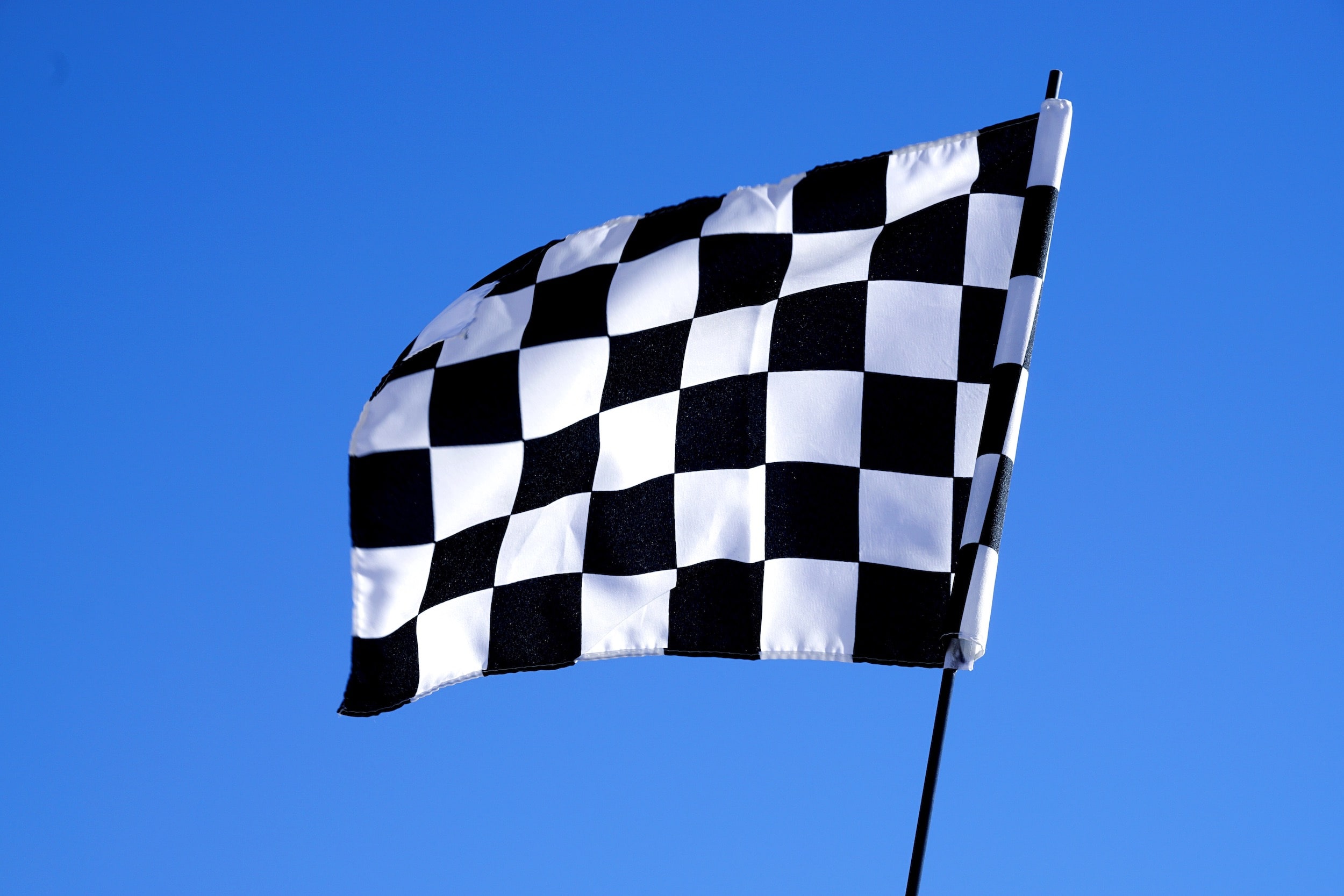 checkered flag with blue sky background